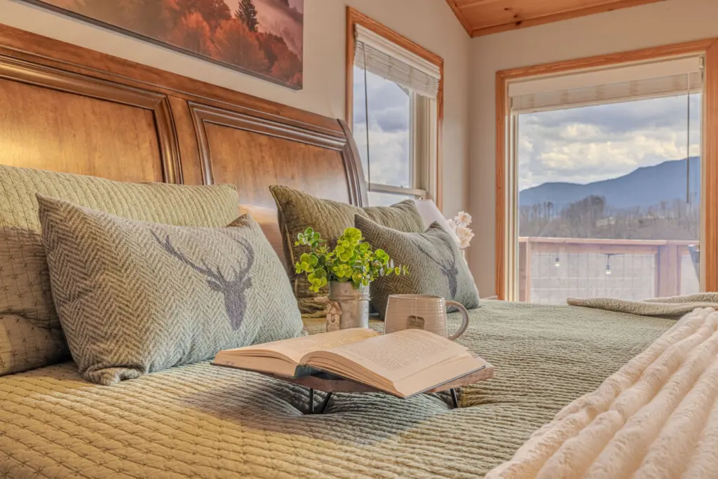 King suite with morning mountain light and private deck access