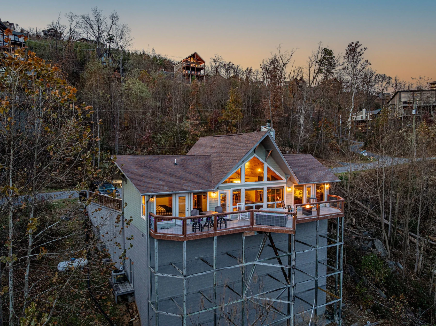 Modern elevated lodge with spacious deck at golden hour in Gatlinburg vacation rental with mountain view