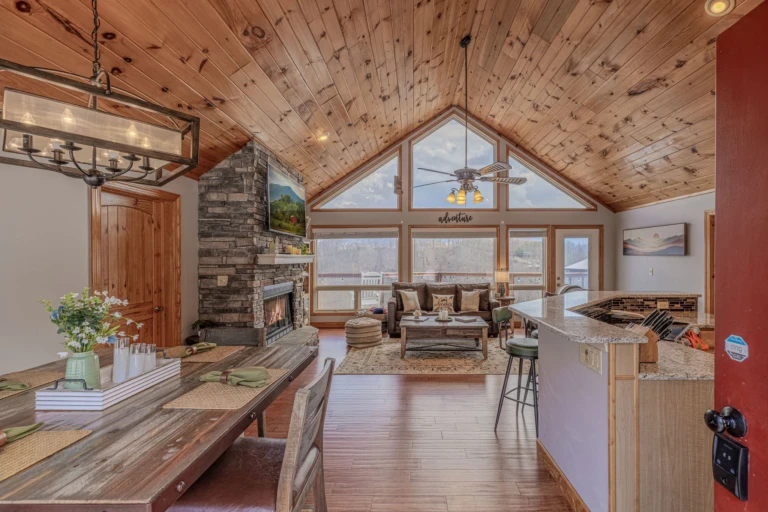 Luxury lodge great room with stone fireplace and mountain views in Gatlinburg