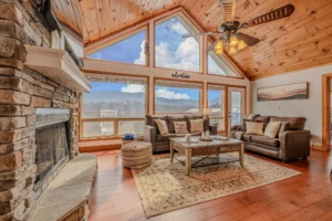 Luxury Gatlinburg vacation rental living room with stone fireplace and mountain views