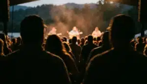 Crowd watching live music at the Gatlinburg Craftsmen's Fair stage under warm haze lighting