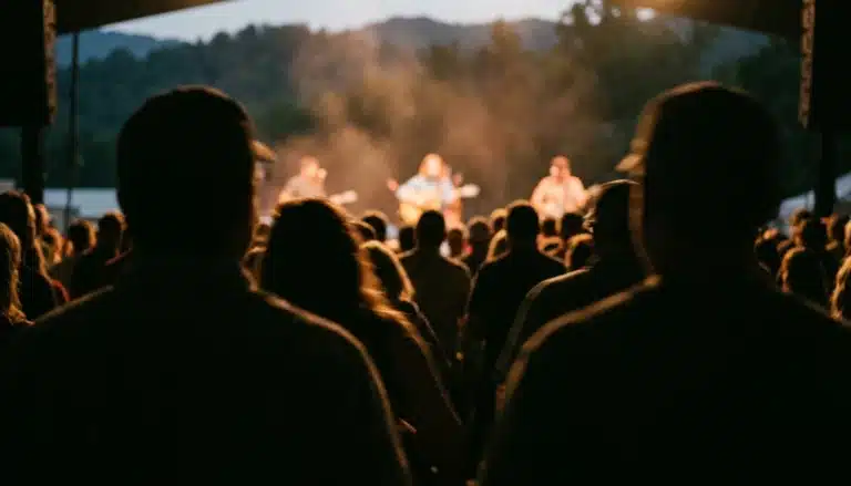 Crowd watching live music at the Gatlinburg Craftsmen's Fair stage under warm haze lighting