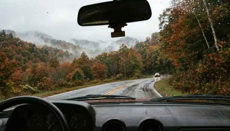 View through a windshield of a misty forested mountain road, one of the scenic drives near Gatlinburg