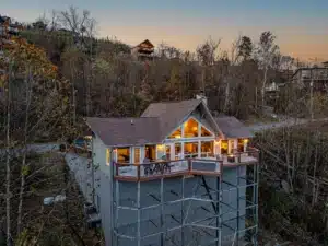 Elevated modern lodge on stilts with a deck, surrounded by autumn forest at golden hour, a best swimming holes near